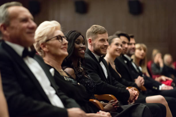 istock Smiling spectators sitting in the theater 1409650054