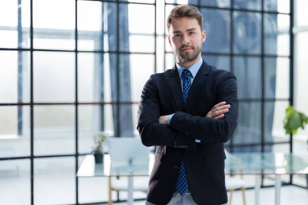 istock Handsome young businessman standing in modern office. 1409650361