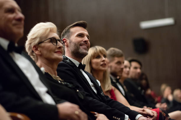 istock Smiling spectators sitting in the theater 1409650402
