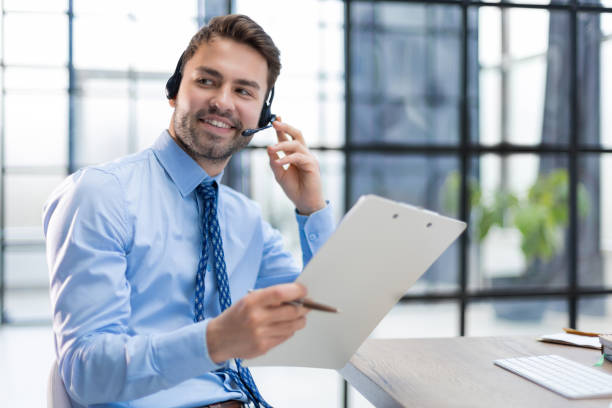 istock Young man is working with papers while sitting in the office. Successful entrepreneur is studying documents with attentive and concentrated look. 1409650437