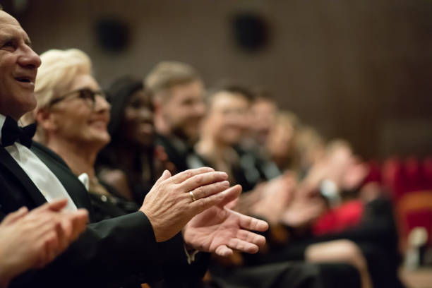 istock Spectators clapping in the theater, focus on hands 1409651142