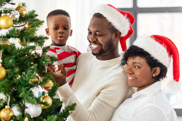 istock happy family decorating christmas tree at home 1409651190