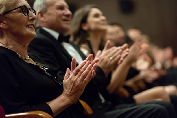 istock Spectators clapping in the theater, focus on hands 1409651257