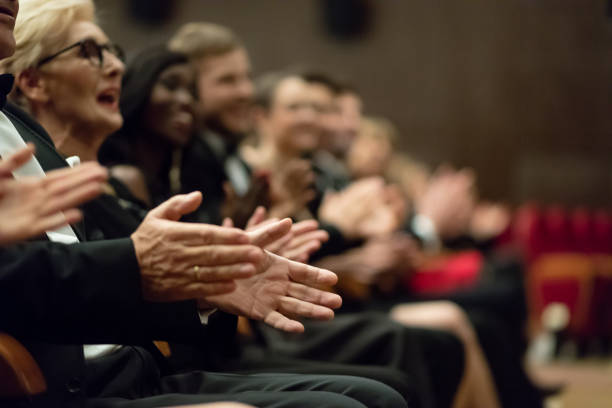 istock Spectators clapping in the theater, focus on hands 1409651833