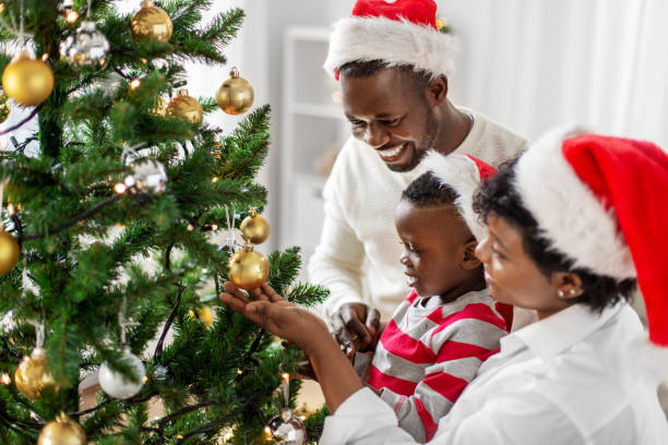 istock happy family decorating christmas tree at home 1409651986