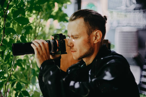 istock male spy private detective with a long lens camera is watching in a cafe. 1409652220