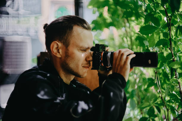 istock male spy private detective with a long lens camera is watching in a cafe. 1409652228