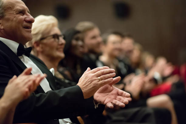 istock Spectators clapping in the theater, focus on hands 1409652363