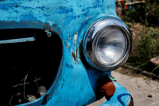 Headlight of old rusty car. vintage round headlight.