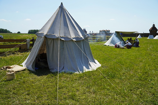 Ulyanovsk, Russia - July 16, 2022: historical Festival (The Great Volga Way). Historical reconstruction. Tents of actors of historical reconstruction on the grass.