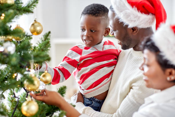 istock happy family decorating christmas tree at home 1409652570