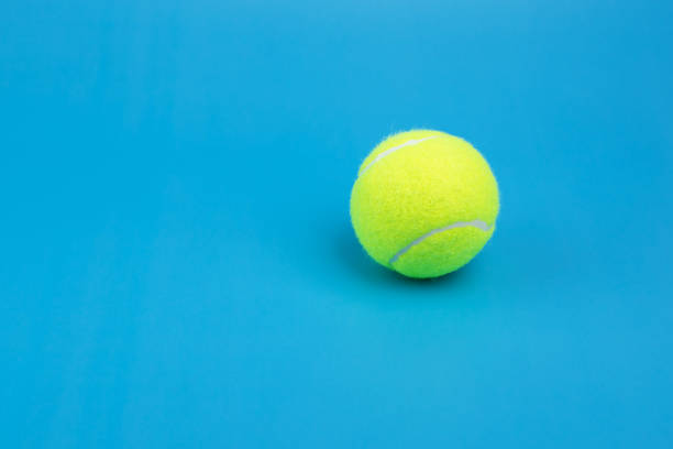 istock tennis ball on blue background copy space 1409652633