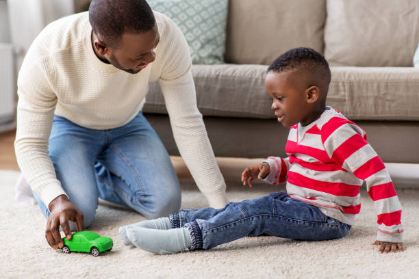 istock happy father playing with son at home 1409653454