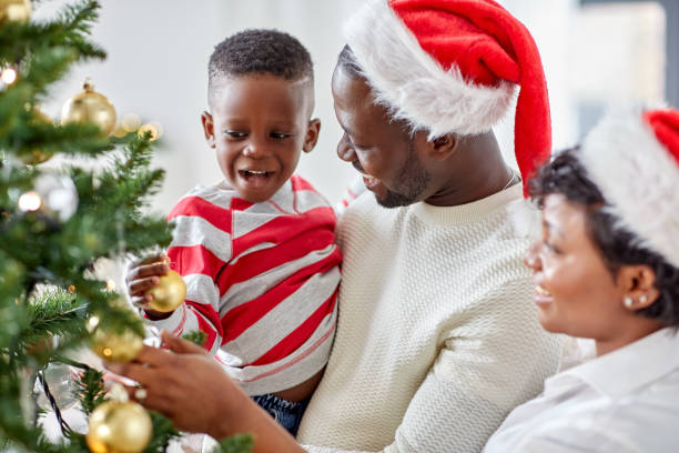 istock happy family decorating christmas tree at home 1409653751