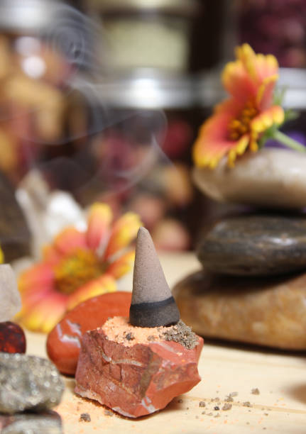 Incense Cone on Stone Slab With Chakra Crystals and Flowers