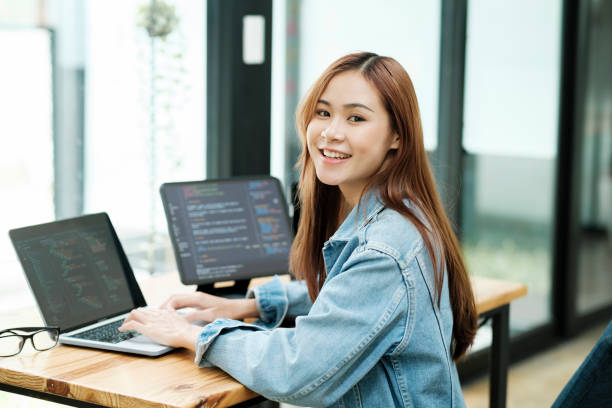 Young programmer or IT specialist satisfied with her work done. stock photo