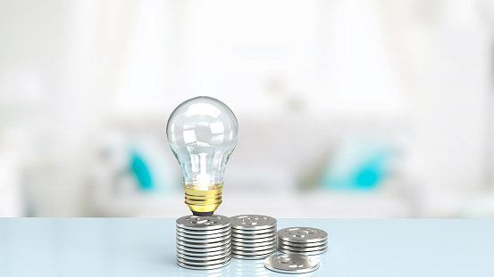 light bulb and silver coins on table for business concept 3d rendering