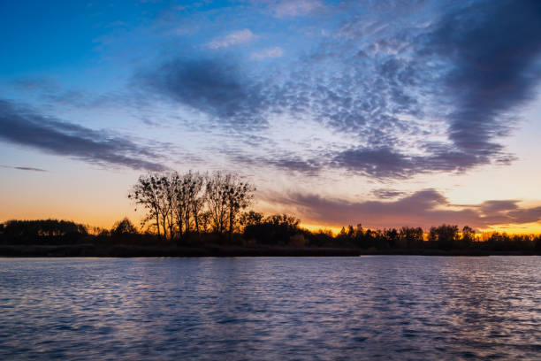 istock Colorful clouds after sunset over the lake 1409658592
