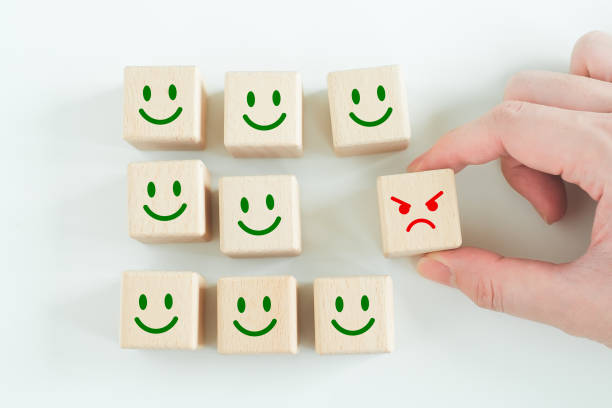 istock Hand pick angry face out from smile face for remove or reject negative thinking and negative emotion. mindset, attitude, satisfaction and Emotional Control. 1409659478