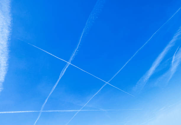 istock contrails cross each other in the blue sky 1409661079