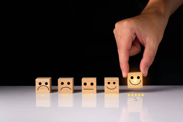 istock Customer service and Satisfaction feedback concept ,Business people show feedback with smile face wooden cube happy Smiley face icon satisfaction in service. wooden cubes rating. wood cubes ideas. 1409661627