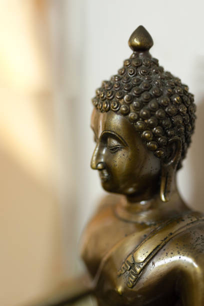 istock Close up Antique Buddha Statue Isolated on Blurry Background, Selective Focus. 1409663469
