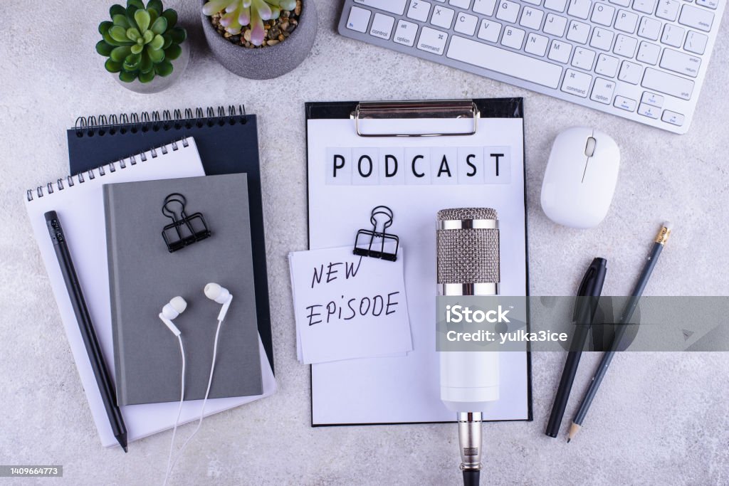 Podcast new episode concept with microphone Podcast new episode concept. Workplace desk of blogger or podcaster with microphone Backgrounds Stock Photo