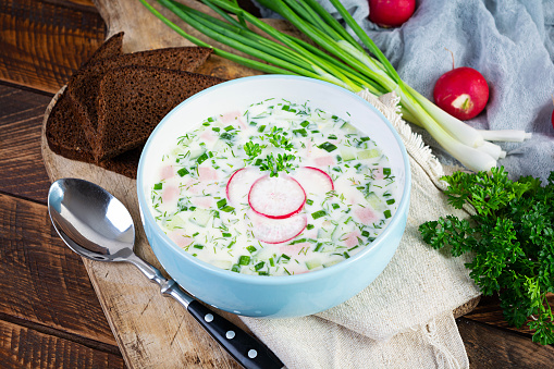 Summer cold soup with yogurt and vegetables. Traditional russian cold soup okroshka