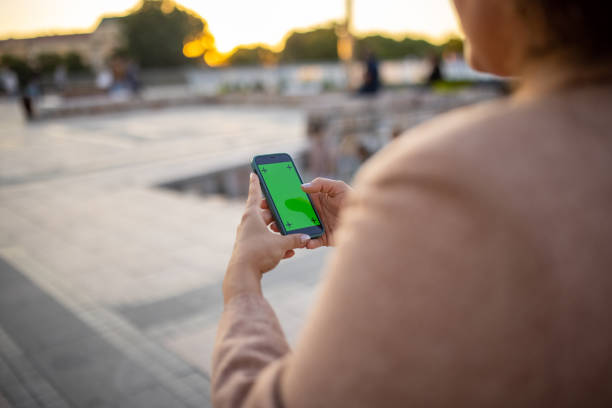 istock Unrecognizable woman using mobile phone, with a chroma key on display 1409666124