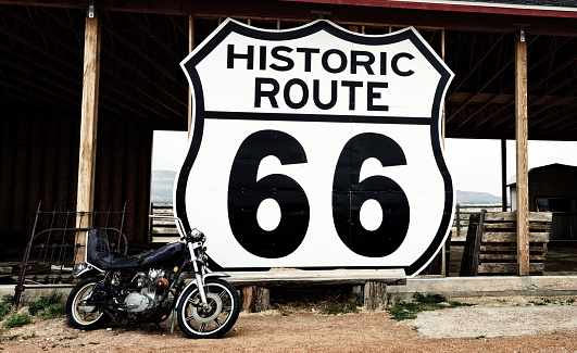 Motorcycle in front of an abandoned shed, Route 66 near to the vintage Frontier motel, Truxton, Mohave county, Arizona, USA.