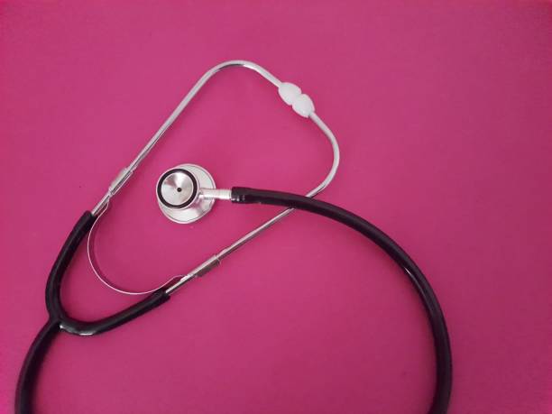 Stethoscope on Pink Background Stethoscope on pink background with space for text , top view. womens issues stock pictures, royalty-free photos & images