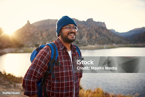 istock A young adult backpacker smiles at the lake view with sunset in the mountains 1409676560