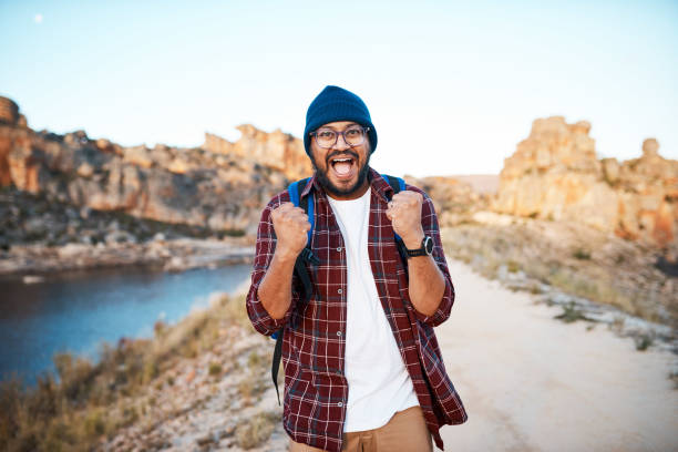 istock An attractive backpacker celebrates reaching the summit lake view while hiking 1409676994
