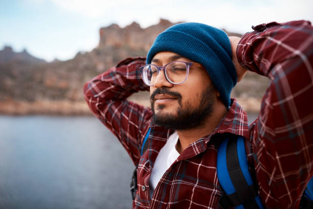 istock A hiking man takes a break and meditates while backpacking through the mountains 1409679396