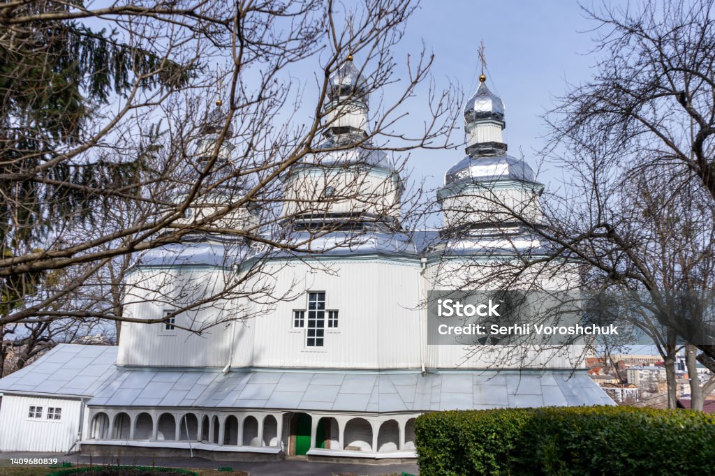 facade of a wooden Christian church with three domes and crosses facade of a wooden Christian church with three domes and crosses. Ancient Stock Photo