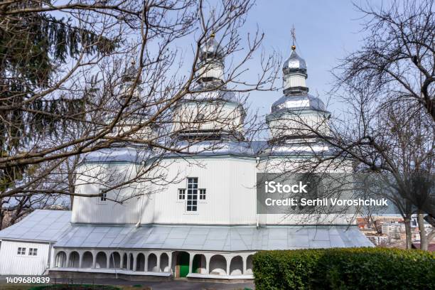 Facade Of A Wooden Christian Church With Three Domes And Crosses Stock Photo - Download Image Now