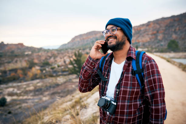 istock An attractive rugged man makes a call in the mountains while backpacking hiking 1409680858
