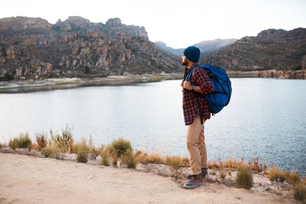 istock A backpacker takes a break at the lake while hiking in the mountains in evening 1409681287