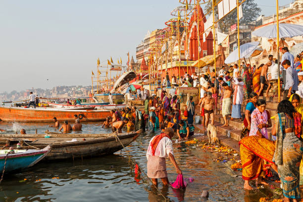 ritual of bathing in the holy Ganges River in Varanasi. stock photo