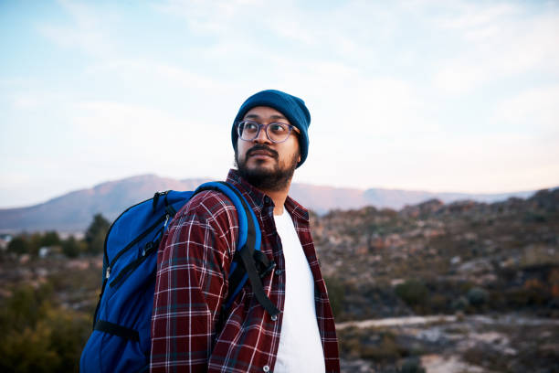 istock A hiking man looks back at the trail while backpacking in the mountains 1409682724