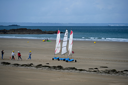 Erquy, France, June 25, 2022- Beach sailing on the Atlantic beach of Erquy in Brittany.