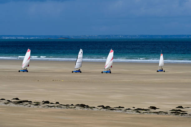 Erquy, France, June 25, 2022- Beach sailing on the Atlantic beach of Erquy in Brittany.