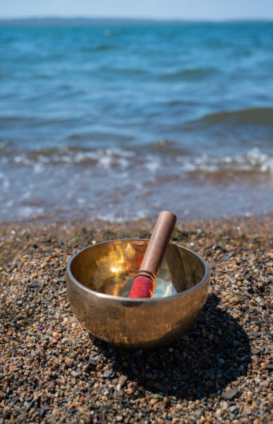 istock Singing (Tibetan) bowl on the shore of the lake. 1409683663