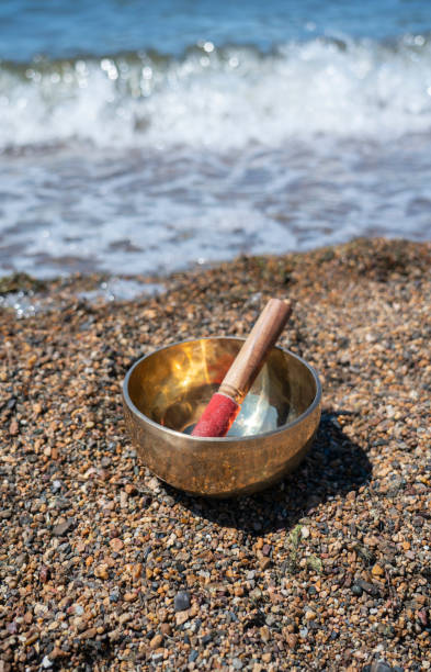 istock Singing (Tibetan) bowl on the shore of the lake. 1409683690