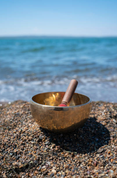 istock Singing (Tibetan) bowl on the shore of the lake. 1409683695