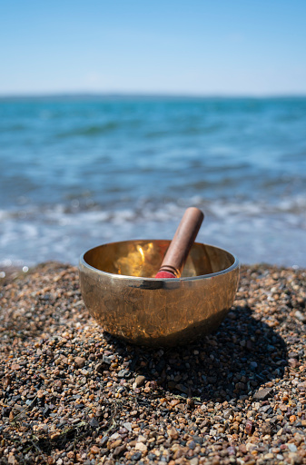 Singing (Tibetan) bowl on the shore of the lake.