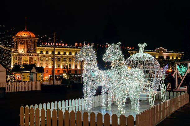 New Year's Cathedral Square in Russian Belgorod city Belgorod, Russia - January 05, 2021: LED light horses with a carriage decoration composition. New Year's Cathedral Square. belgorod photos stock pictures, royalty-free photos & images