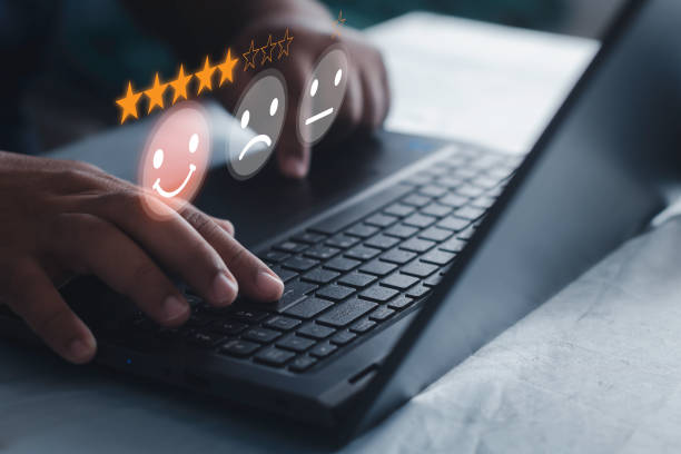 istock Businessman using laptop computer satisfaction survey and evaluation concept on virtual screen 1409687535