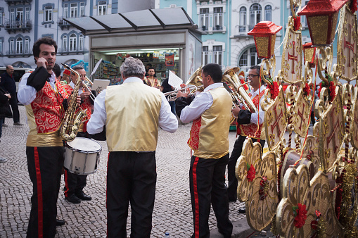 Lisbon, Portugal - June 12, 2015: Band musicians dressed in traditional folklore costumes, rehearse before taking part on a parade in Lisbon downtown, celebrating this city Popular Saints.
