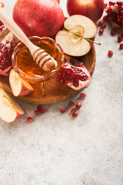 istock Rosh Hashanah. Pomegranate, apples and honey traditional products for celebration on rustic grey background. Jewish Autumn Rosh Hashana celebration. Jewish holiday Rosh Hashana design. Selective focus 1409688794